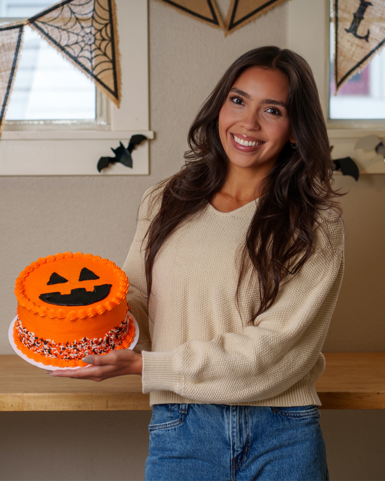 Chelsey Carlson — Provo Bakery, holding a pumpkin cake