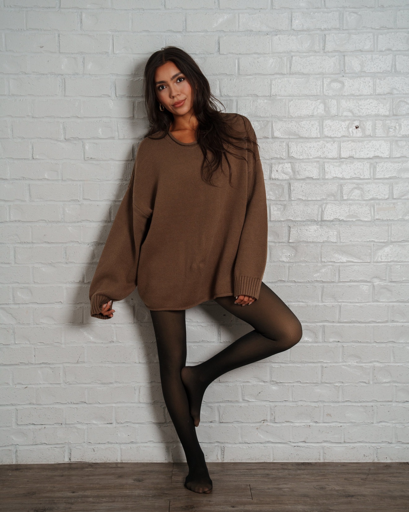 Chelsey Carlson — brown sweater editorial, leg raised pose